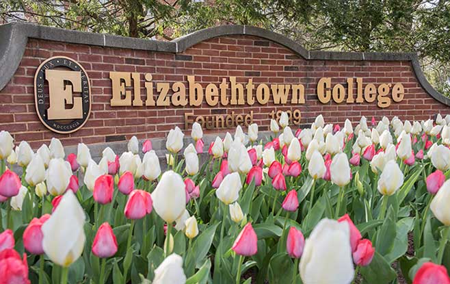 Elizabethtown college sign on a brick wall